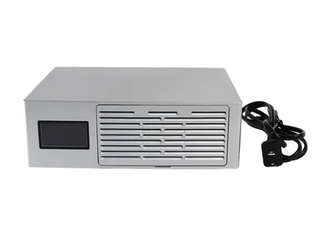 Lucky Miner LV08 Pro, a silver desktop miner with a screen, beside its power cord