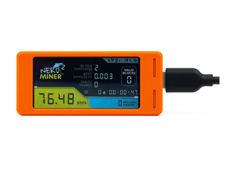 NerdMiner v2 in an orange case, its screen showing hashrate and shares, with a USB-C cable